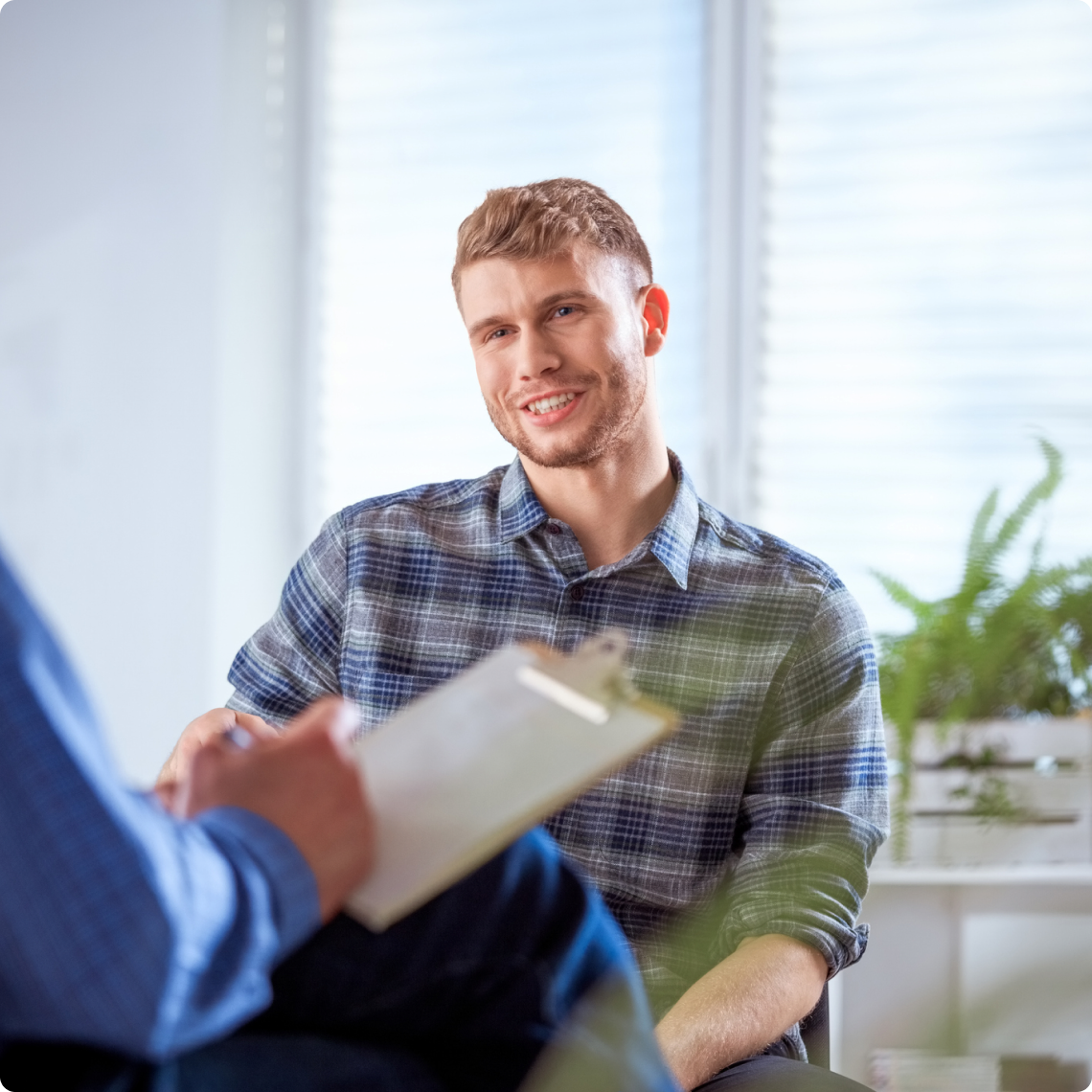 Man smiling during a counseling session.